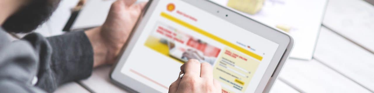 man holding tab and looking at the website