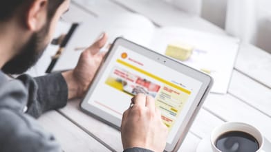 man holding tab and looking at the website