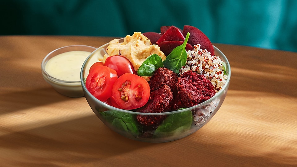 Na vizuáli možno vidieť poke misku s qinoou, falafelom a vybranou zeleninou.