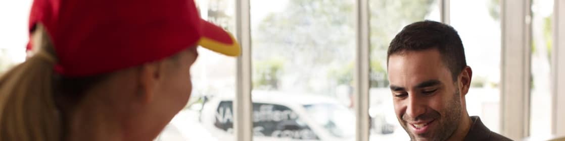 man giving loyalty card to shell employee